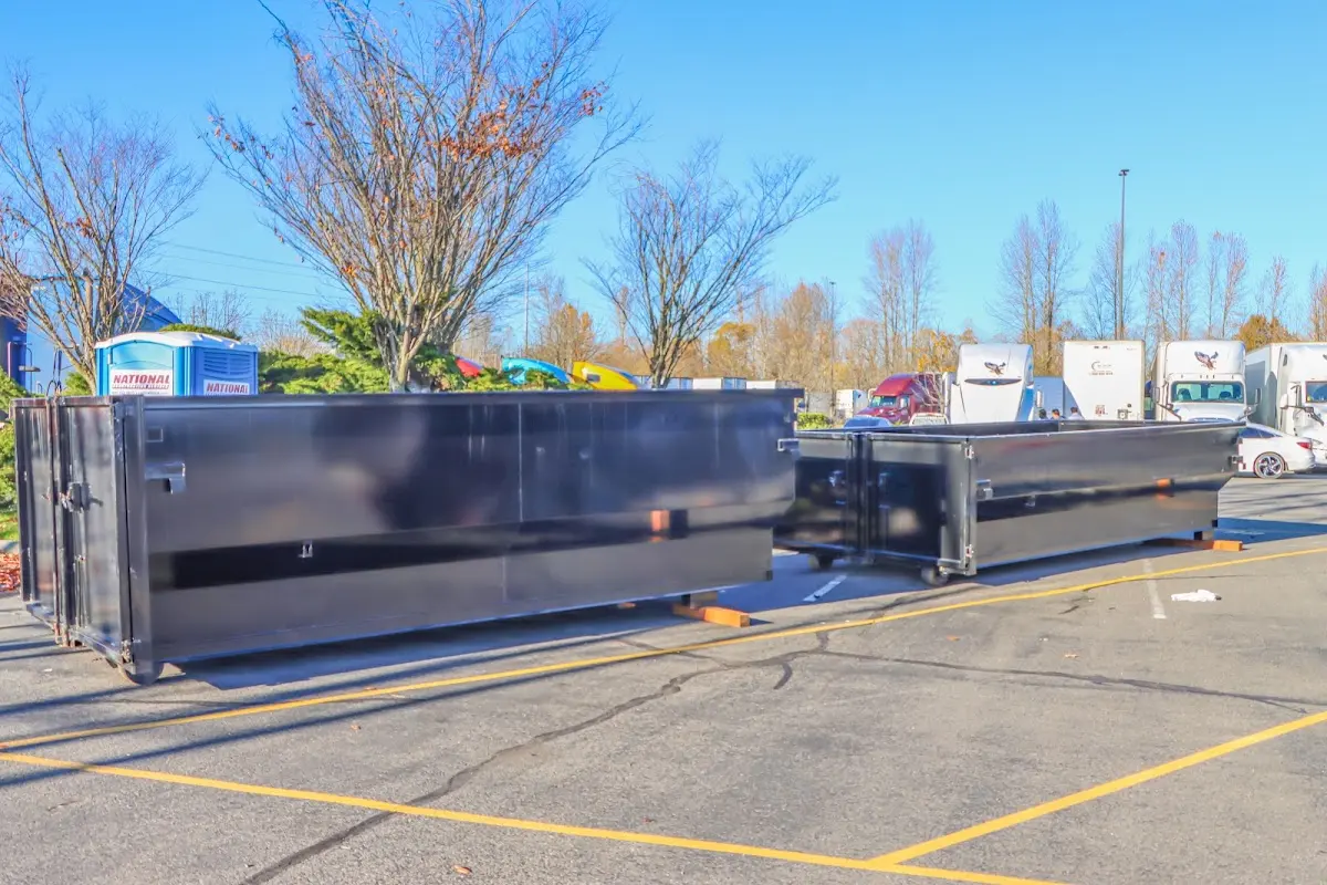 Professional dumpster rental service with roll-off container on residential driveway in Eastchester